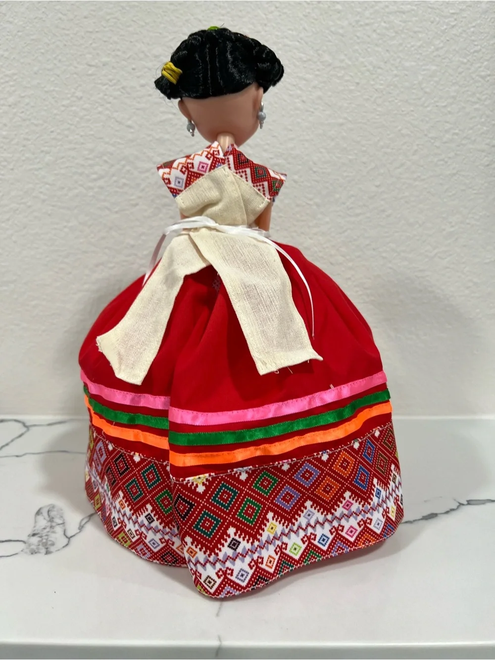 Red Traditional Folk Doll with Colorful Ribbon Accents